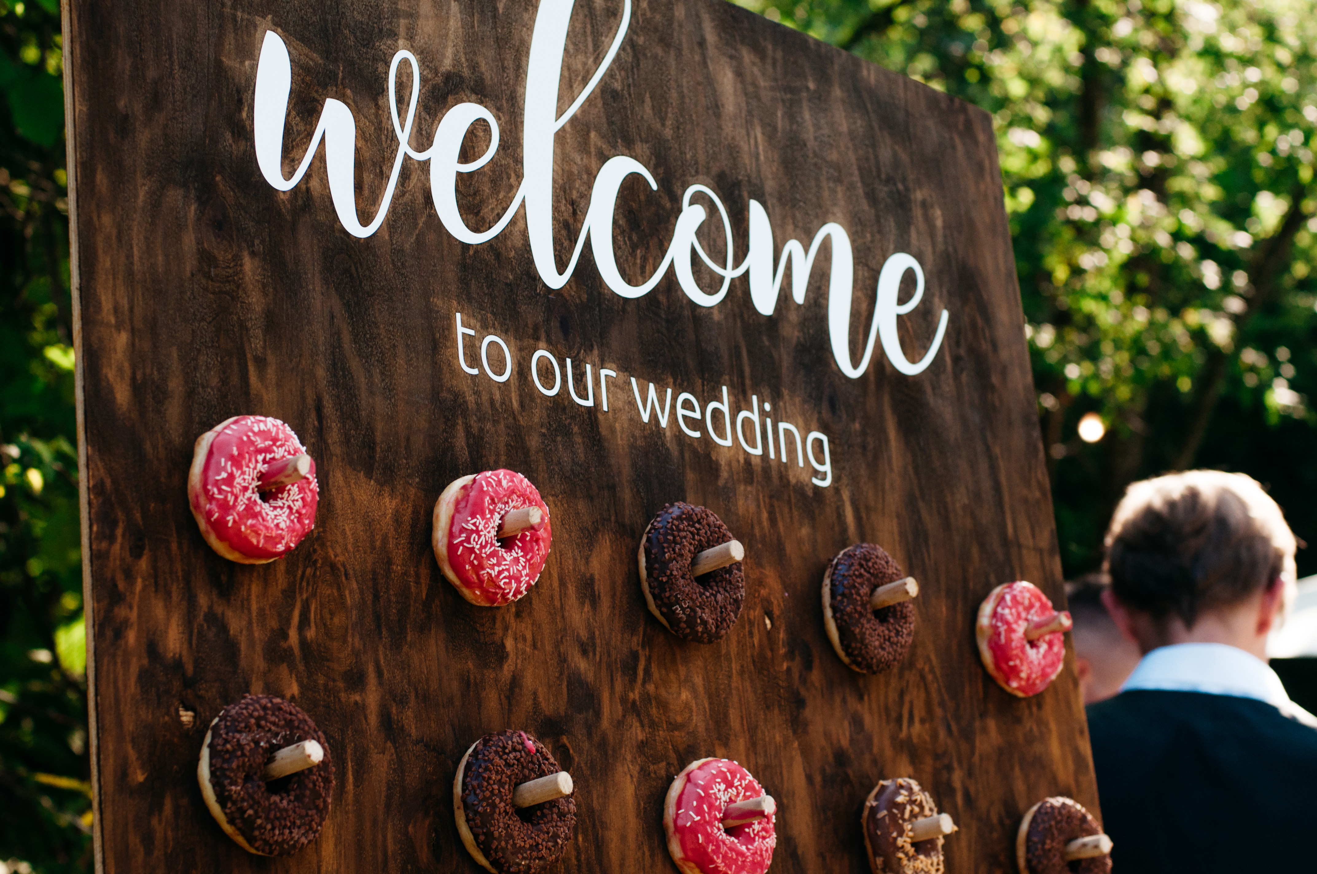 Wooden,Wall,Full,Of,Delicious,Donuts.,Wedding,Decoration.,Welcome,To